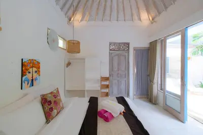 a white room with a bed and a large window at Beji Ayu Seminyak - 1 Bedroom Private Villa in Seminyak