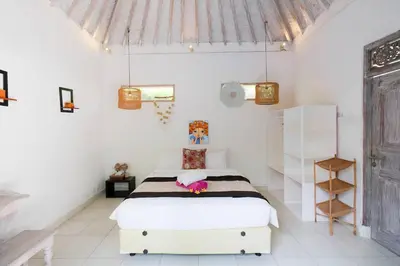 a bedroom with a bed in a white room at Beji Ayu Seminyak - 1 Bedroom Private Villa in Seminyak