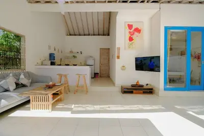 a living room with a couch and a table at Beji Ayu Seminyak - 1 Bedroom Private Villa in Seminyak