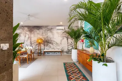 a dining room with plants on the wall at CS 2 Luxurious 3 BR New Villa Near Double Six Beach in Seminyak
