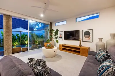 a living room with a couch and a tv at CS 2 Luxurious 3 BR New Villa Near Double Six Beach in Seminyak