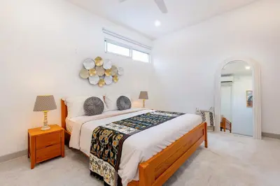 a bedroom with a large bed and a window at CS 2 Luxurious 3 BR New Villa Near Double Six Beach in Seminyak