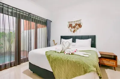 a bedroom with a bed with two towels on it at Nice Villa In Seminyak #YoNa in Seminyak
