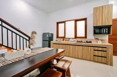 a kitchen with a table and chairs and a counter at Nice Villa In Seminyak #YoNa in Seminyak