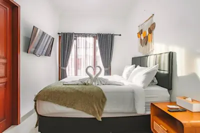 a bedroom with a bed with a bow on it at Nice Villa In Seminyak #YoNa in Seminyak