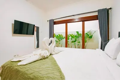 a bedroom with a bed with a towel on it at Nice Villa In Seminyak #YoNa in Seminyak