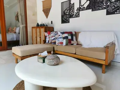 a living room with a couch and a table at RK4 Brand New 2Bedroom Villa Near Seminyak in Seminyak
