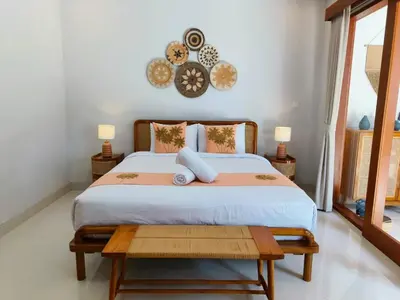 a bedroom with a large bed with two pillows at RK4 Brand New 2Bedroom Villa Near Seminyak in Seminyak