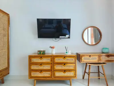 a dresser with a tv on a wall with a mirror at RK4 Brand New 2Bedroom Villa Near Seminyak in Seminyak