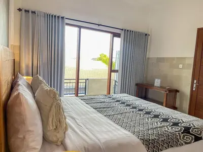 a bedroom with a bed and a large window at RK5, 2 beds villa 15 min walk to Double Six Beach in Seminyak