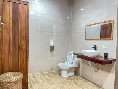 a bathroom with a white toilet and a sink at RK5, 2 beds villa 15 min walk to Double Six Beach in Seminyak