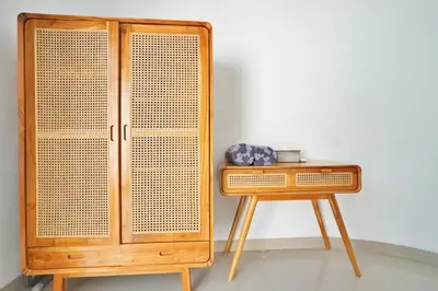 a wooden cabinet sitting next to a table at Bright, Airy & Private, your 2BR Bali Escape in Seminyak