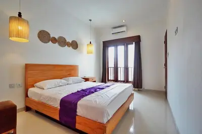 a bedroom with a bed and a large window at NR Villa, 2 Bedroom Villa Kerobokan in Seminyak