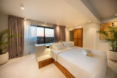 a bedroom with a large bed and a large window at Gate 11 Mezzanine one in Denpasar