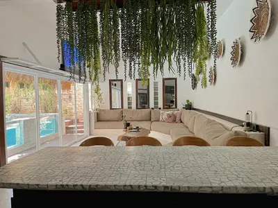 a living room with a couch and a table at Villa Vela 2 BR - Vela 3 with Private Pool & Rooftop in Seminyak