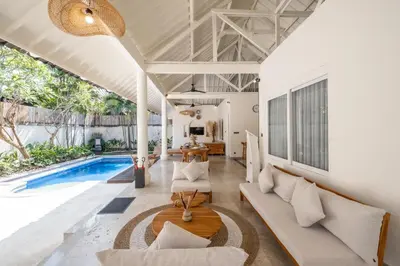 an open living room with a pool and a villa at Uma dharma villas 2 in Seminyak