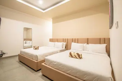 a bedroom with two beds with white sheets at Splendid Villa 3Br Center Seminyak in Seminyak