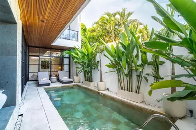 an indoor pool in a house with plants at Modern 3BR Villa Seminyak, central location in Seminyak