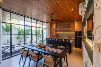a kitchen and dining room with a table and chairs at Modern 3BR Villa Seminyak, central location in Seminyak