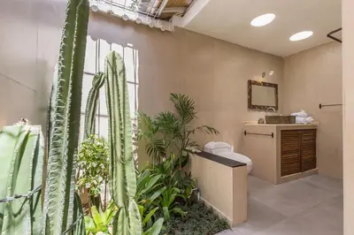 a bathroom with plants and a toilet and a sink at Villa Sarah 4 chambres près de la plage Oberoi Seminyak in Seminyak