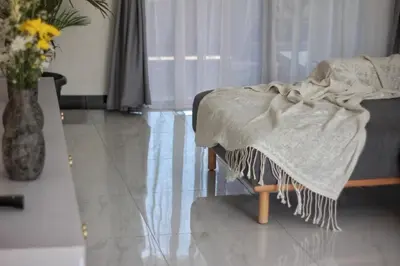 a blanket on a bed in a living room at Villa Lisa - 3BR with pool Near Bali Mall Galleria in Kuta
