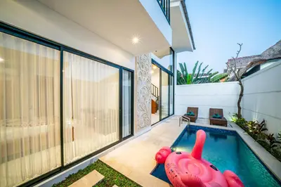 a house with a swimming pool in the backyard at Villa Lavender Seminyak in Seminyak