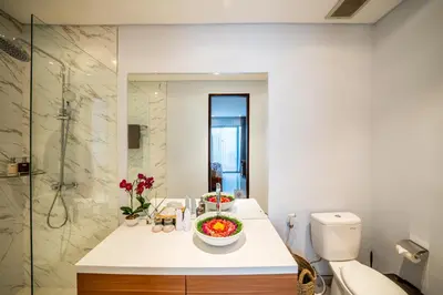 a bathroom with a toilet and a bowl of fruit on a counter at Villa Lavender Seminyak in Seminyak