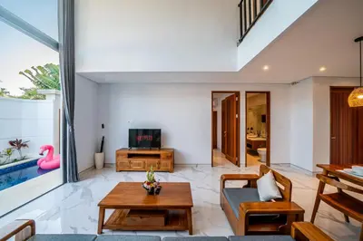 a living room with a couch and a table at Villa Lavender Seminyak in Seminyak