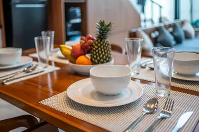 a wooden table with a bowl of fruit on top of it at Villa Lavender Seminyak in Seminyak