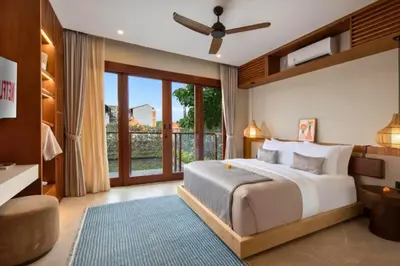 a bedroom with a large bed and a large window at Annora Cozy 3 BR Private Pool Villa in Canggu