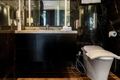 a bathroom with a sink and a toilet and a mirror at The Umalas Signature in Canggu