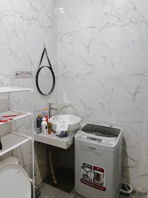 a bathroom with a toilet and a sink at Room Close to Seminyak - Cozy & Strategic Stay in Seminyak