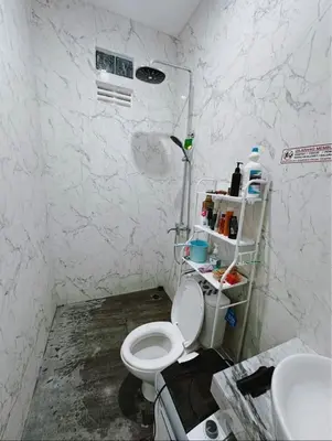 a bathroom with a white toilet and a sink at Room Close to Seminyak - Cozy & Strategic Stay in Seminyak