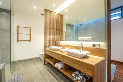 a bathroom with a sink and a mirror at Exquisite 6-Bedroom Retreat, Jacuzzi, AC in Canggu