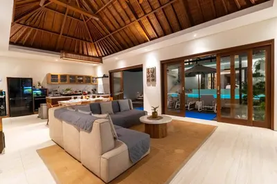 a living room with a couch and a table at Luxury 4BR Private Pool Villa, Serene Lux Jimbaran in Jimbaran