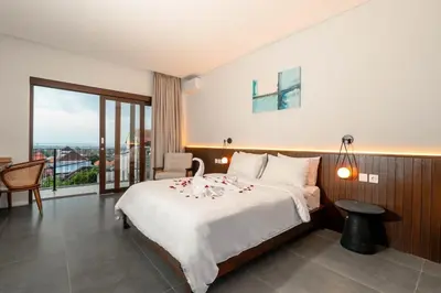 a hotel room with a bed and a balcony at Luxury 4BR Private Pool Villa, Serene Lux Jimbaran in Jimbaran