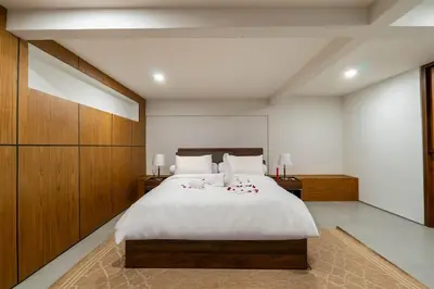 a bedroom with a large bed with white sheets and pillows at Luxury 4BR Private Pool Villa, Serene Lux Jimbaran in Jimbaran