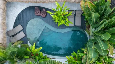 an overhead view of a swimming pool with plants at Villa Mimpikita - Stunning Ibiza-Inspired Villa Near Umalas with Private Pool in Kerobokan