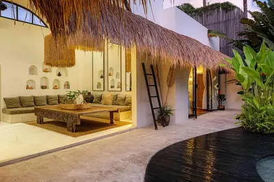 a living room with a couch and a table at Villa Mimpikita - Stunning Ibiza-Inspired Villa Near Umalas with Private Pool in Kerobokan