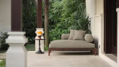 a chair in front of a wall of plants at Taman Estate by Ekosistem in Seminyak