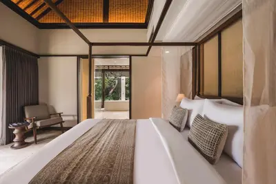a bedroom with a large bed in a room at Taman Estate by Ekosistem in Seminyak