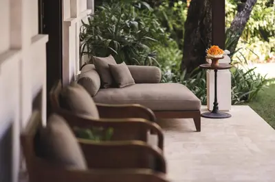 a porch with a couch and a table at Taman Estate by Ekosistem in Seminyak