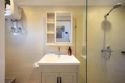 a bathroom with a sink and a shower at Cove Nuansa Home in Jimbaran