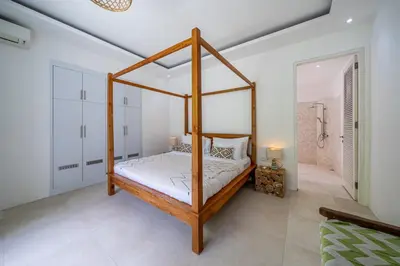a bedroom with a canopy bed in a room at The Oasis Villa in Kerobokan