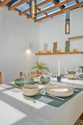 a kitchen counter with plates and dishes on it at Rosso Verde 2BR Villa near Seminyak in Seminyak