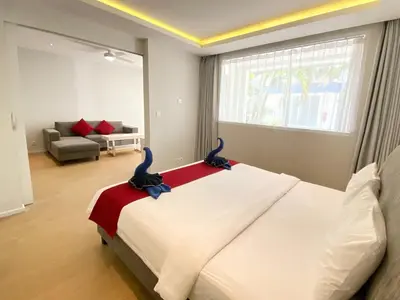 a bedroom with a bed with two birds on it at Coast Boutique Hotel in Kuta