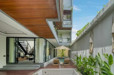 an external view of a house with a balcony at Modern 4BR Industrial - Tropical Escape in Umalas in Kerobokan