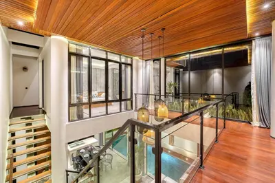 a room with a glass table and some windows at Modern 4BR Industrial - Tropical Escape in Umalas in Kerobokan