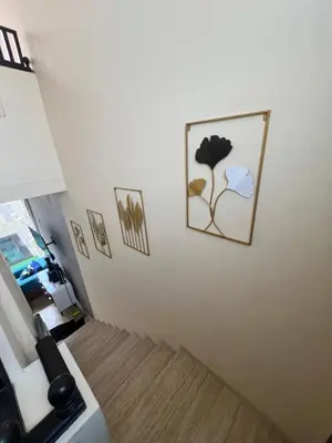 a white wall with a picture of a flower on it at The Fatul Villa in Ngurah Rai International Airport
