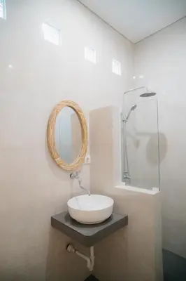 a bathroom with a sink and a mirror at Adijaya Room 1 in Seminyak